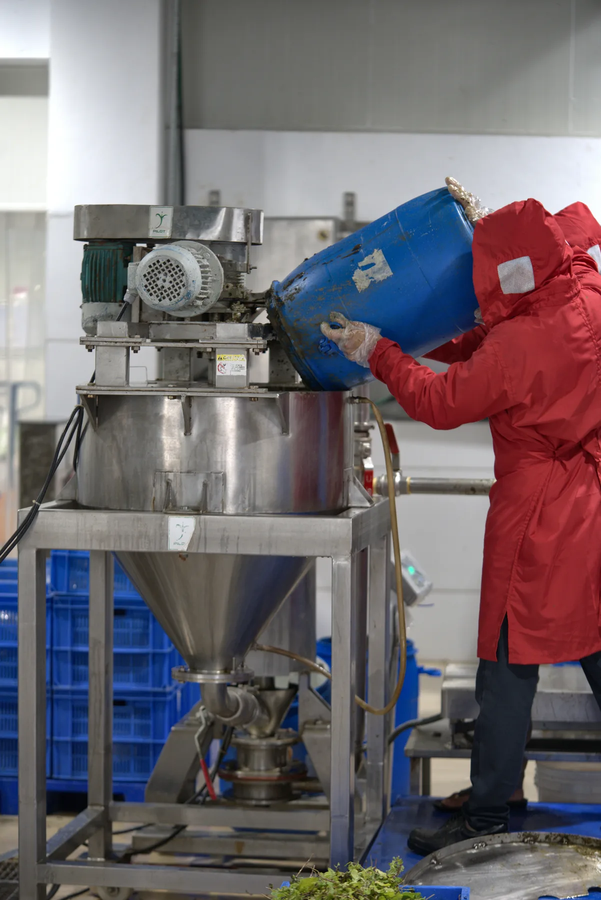 Operator working with production equipment inside a Shree Additives facility