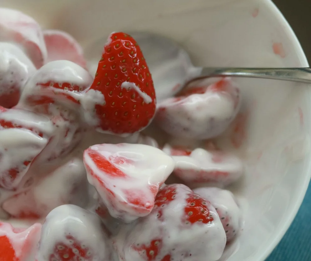 Fresh strawberries folded into creamy white yoghurt
