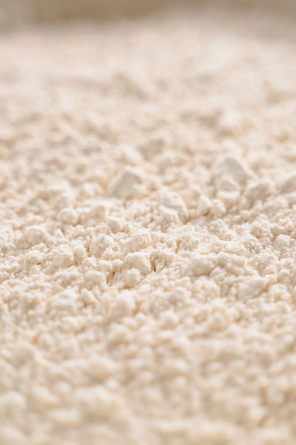 Close-up of a fine, off-white food powder, used as an ingredient illustration